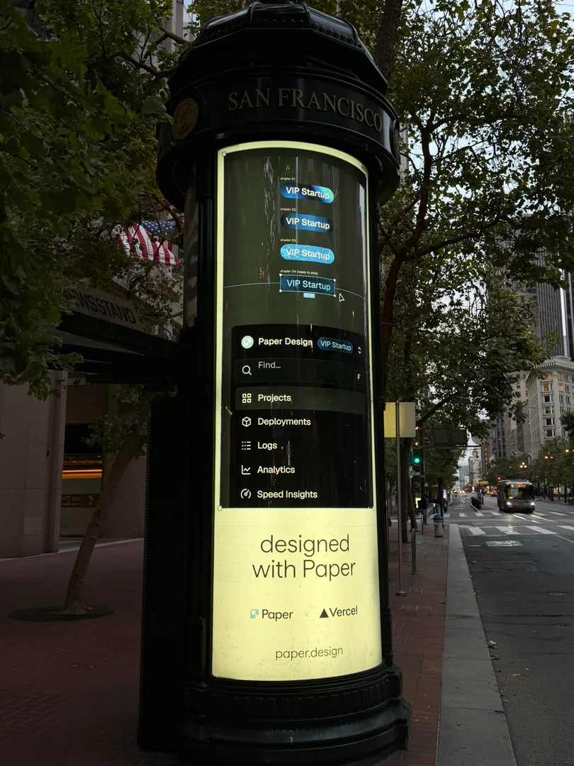 A Paper newsstand by a city signpost